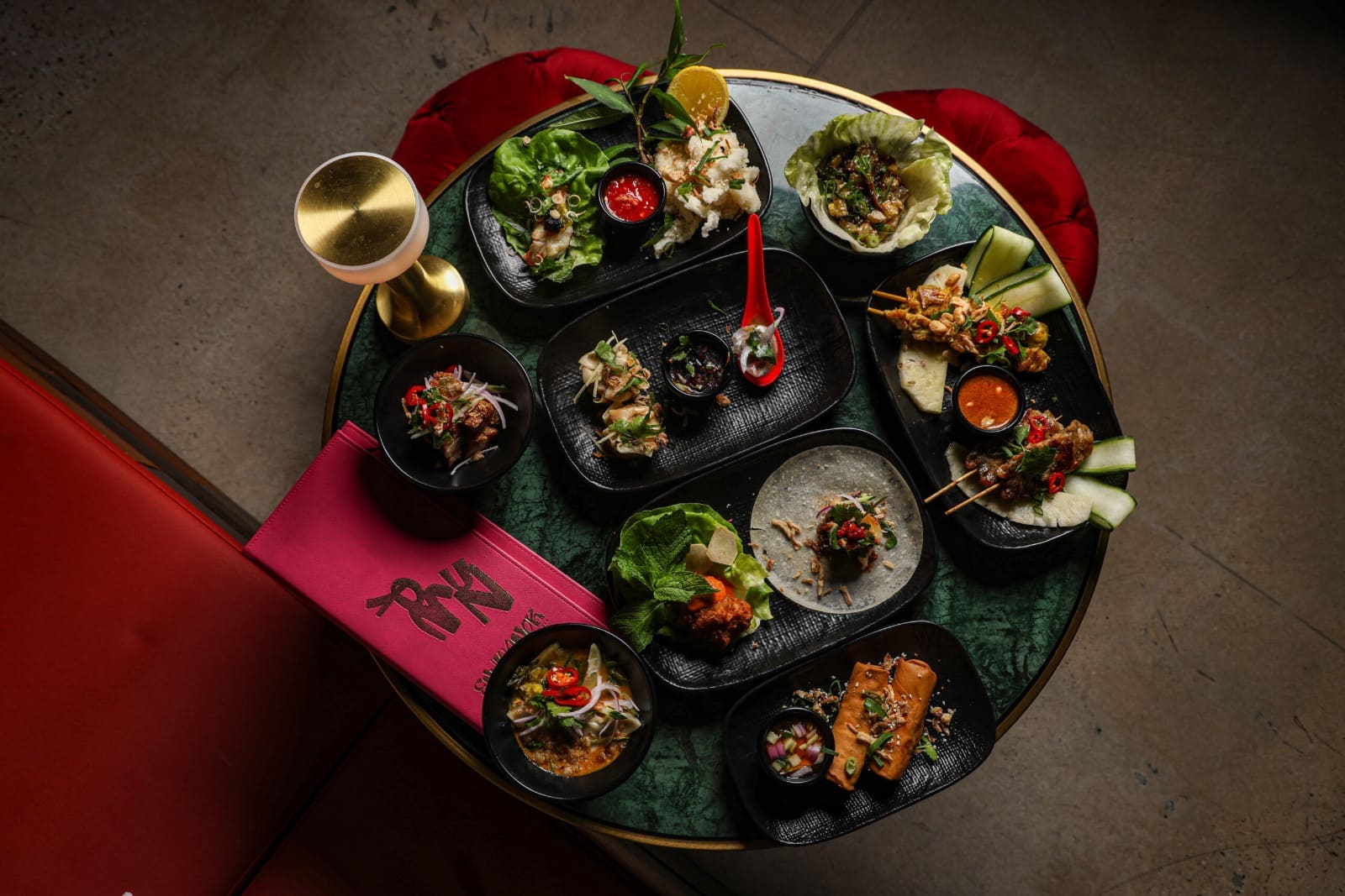Banquet dishes on a round green marble table, seen from above