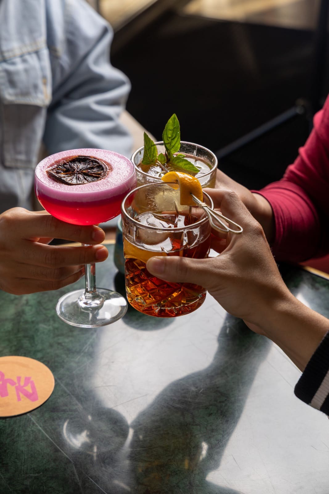 Friends clinking cocktails