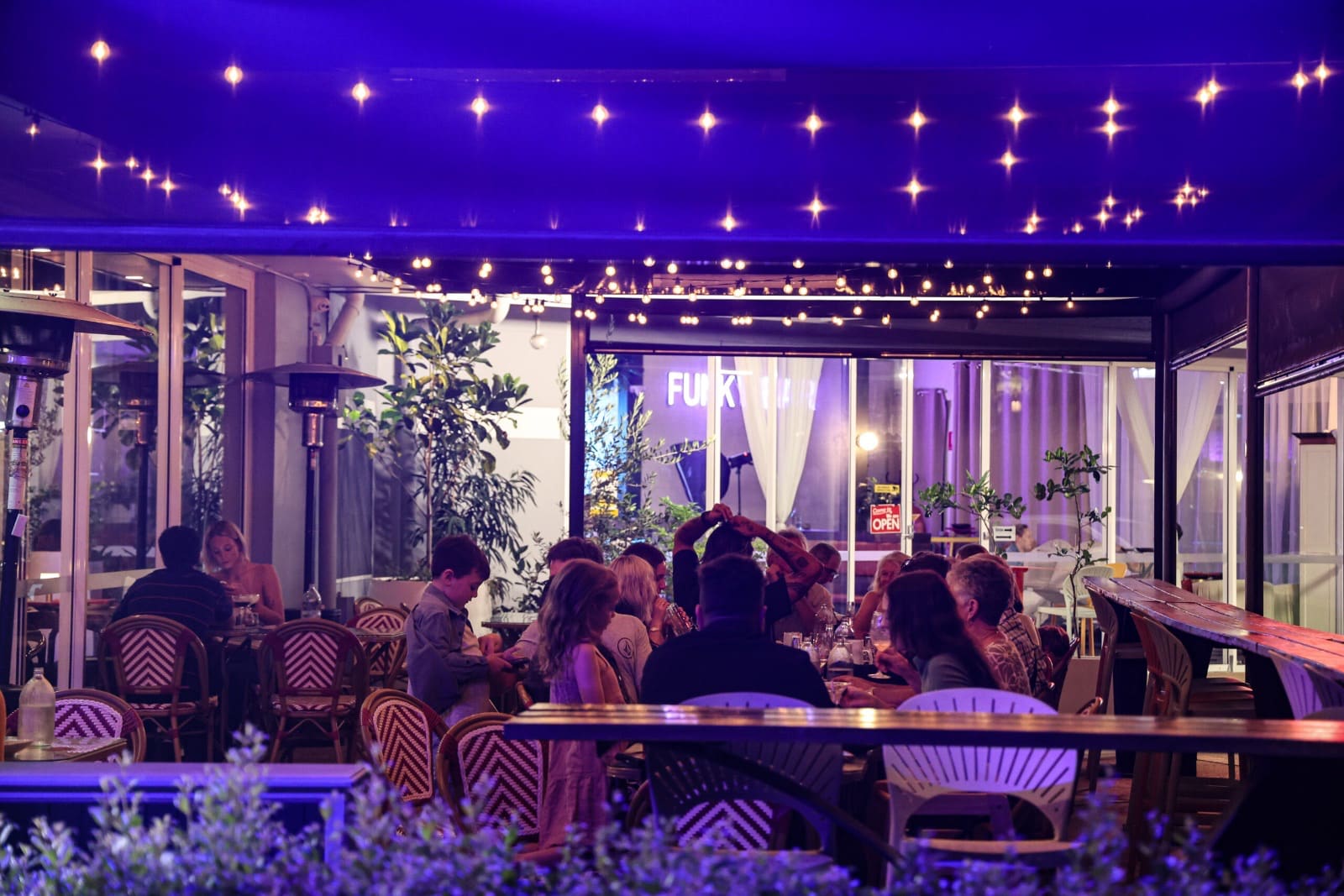 The courtyard at night under festoon lights